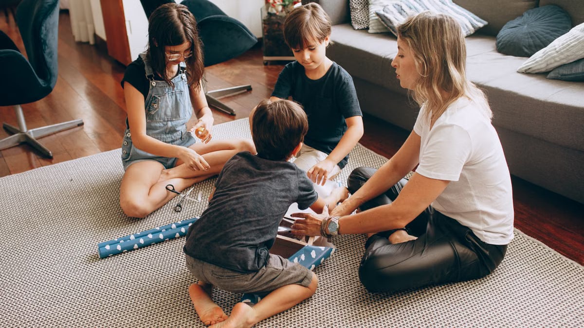 A family wrapping gifts together in a cozy living room setting, showcasing warmth and togetherness.